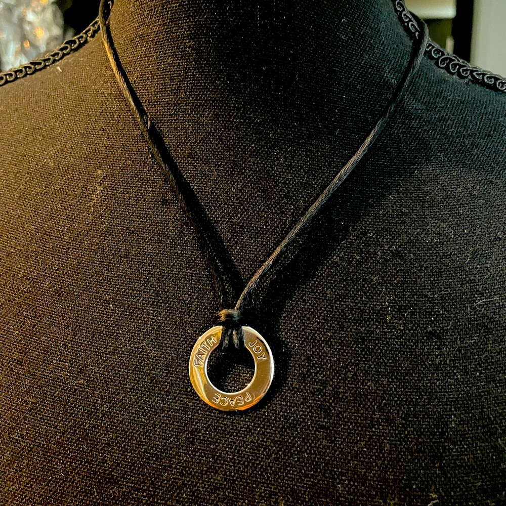 Peace-Joy-Faith- round silver plated charm on a black silk necklace
